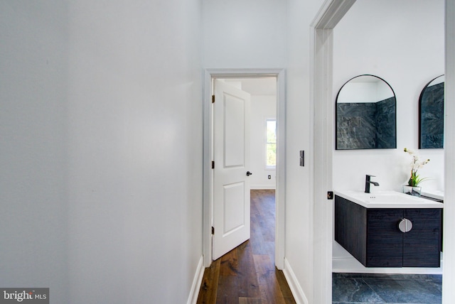 hall with sink and dark hardwood / wood-style floors