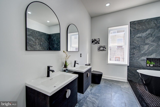 bathroom featuring vanity and a tub