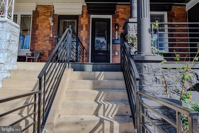 view of exterior entry with covered porch