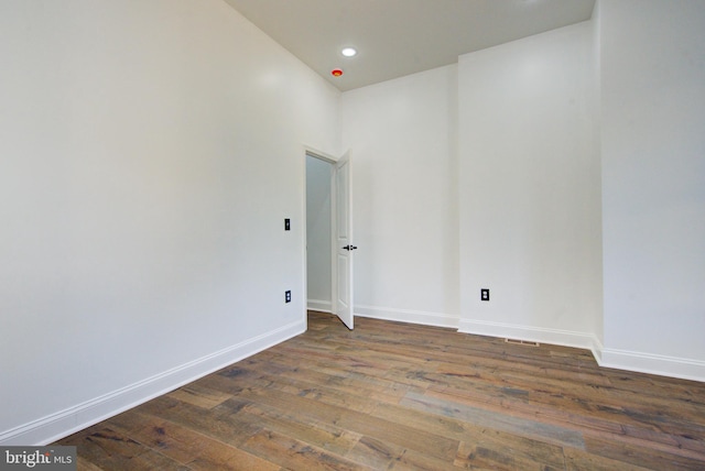 unfurnished room with dark hardwood / wood-style floors