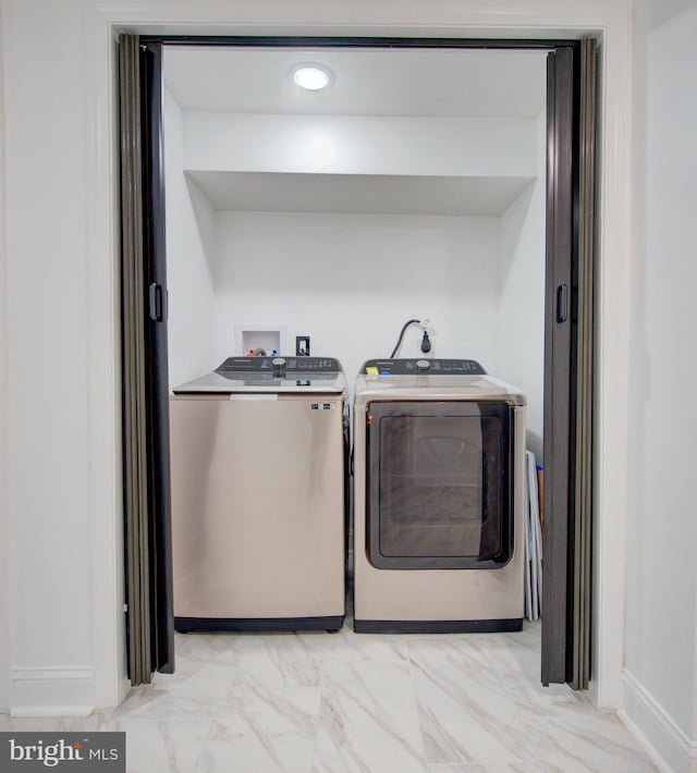 laundry area featuring washing machine and clothes dryer