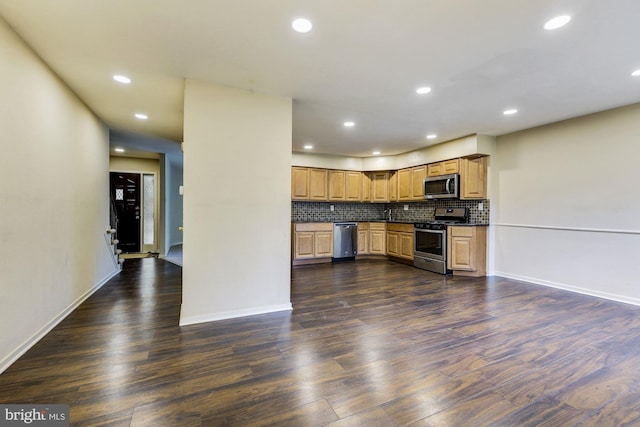 kitchen with tasteful backsplash, stainless steel appliances, and dark hardwood / wood-style flooring