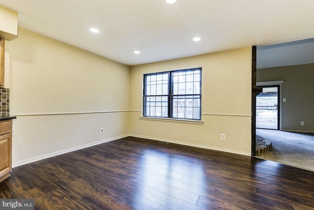 spare room with dark hardwood / wood-style floors