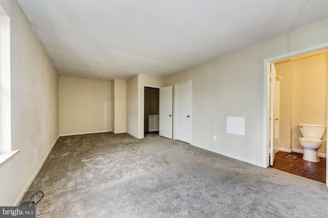 unfurnished bedroom with carpet flooring and ensuite bath