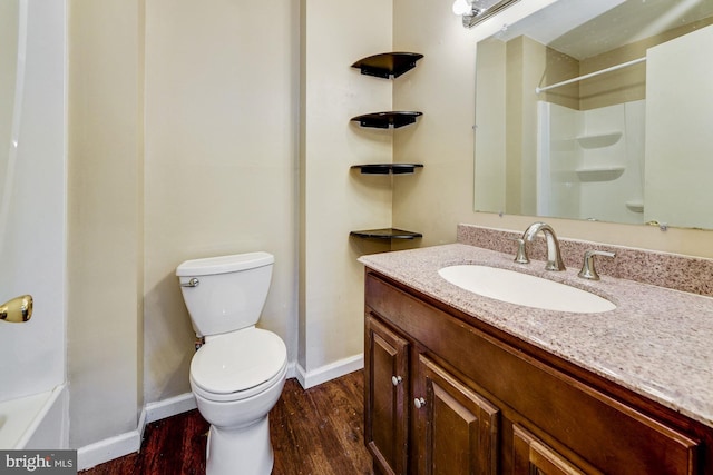 full bathroom featuring vanity, hardwood / wood-style flooring, toilet, and shower / bath combination