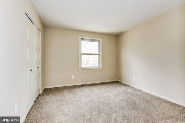 unfurnished bedroom with light colored carpet