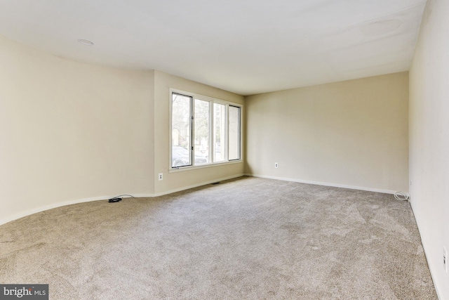 spare room with light colored carpet