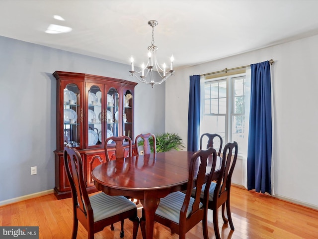 dining room featuring an inviting chandelier and light wood-type flooring