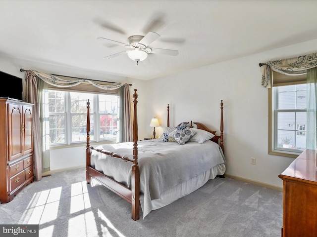 bedroom featuring ceiling fan and light carpet