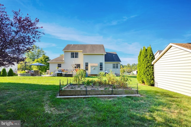 rear view of property featuring a lawn