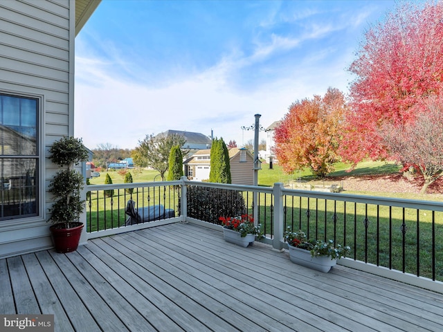 wooden terrace with a yard