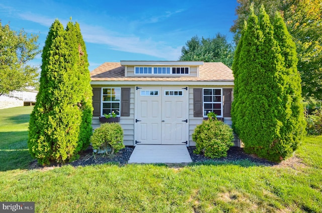 view of outbuilding with a yard