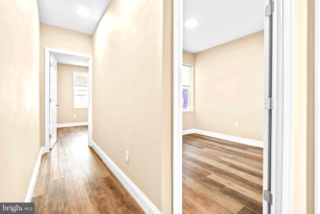 hall featuring wood finished floors and baseboards