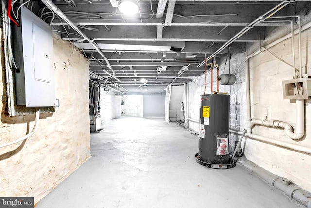 unfinished basement with heating unit, electric panel, and electric water heater