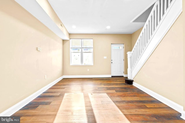 foyer with baseboards, recessed lighting, wood finished floors, and stairs