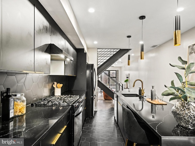 kitchen with dark tile patterned floors, decorative backsplash, hanging light fixtures, sink, and black appliances