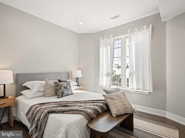 bedroom with dark wood-type flooring