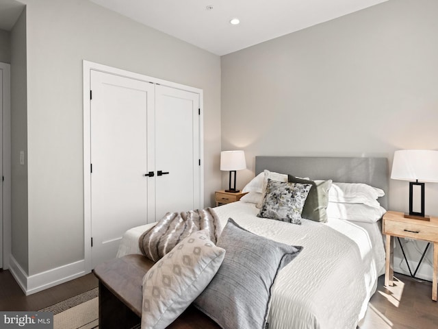 bedroom featuring a closet and dark hardwood / wood-style flooring