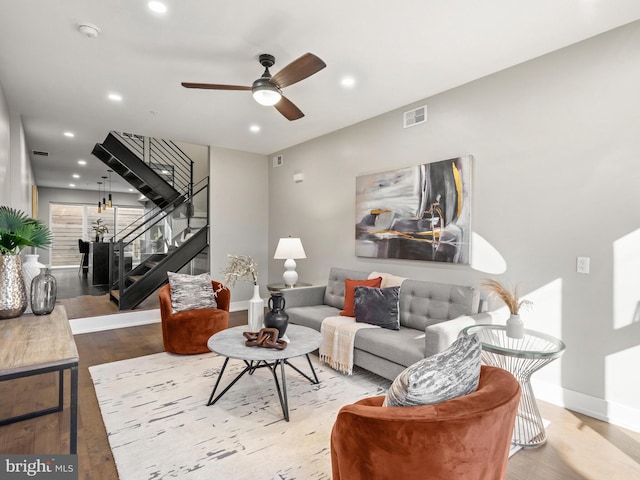 living room featuring light hardwood / wood-style floors and ceiling fan