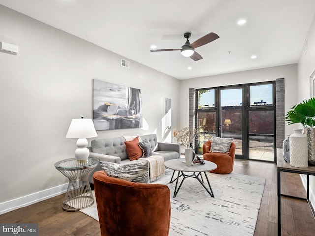 living room with hardwood / wood-style floors and ceiling fan