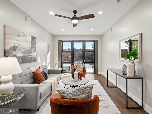 living room featuring ceiling fan and hardwood / wood-style flooring