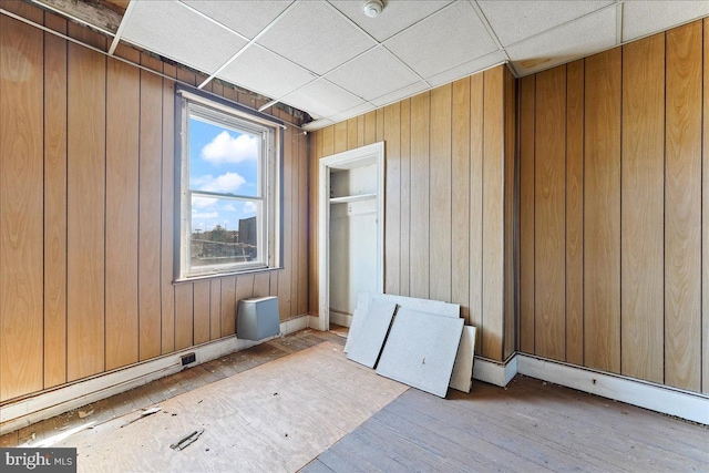 2072 E Clearfield St, Philadelphia, PA 19134 - unfurnished bedroom featuring wood finished floors, wooden walls, and a drop ceiling