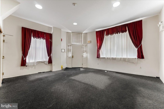 entrance foyer with a healthy amount of sunlight and carpet