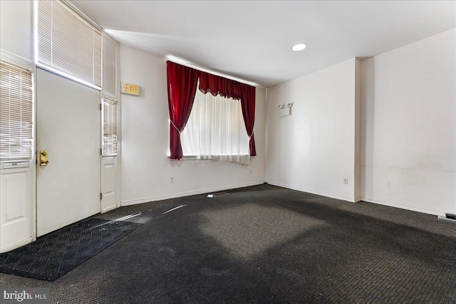 unfurnished room featuring carpet flooring and plenty of natural light