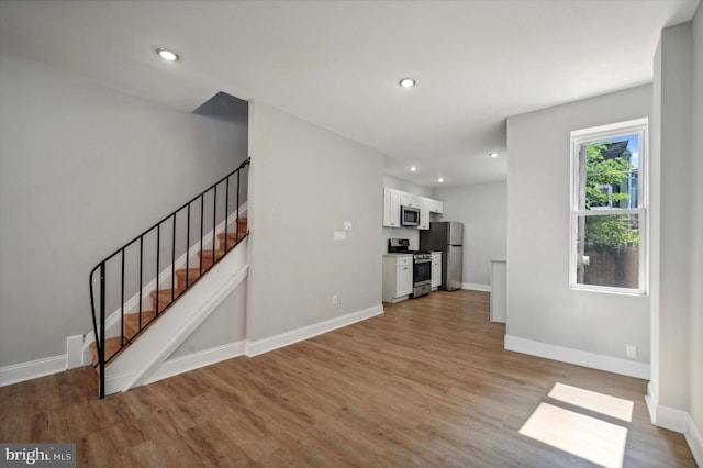 unfurnished living room featuring light wood-type flooring