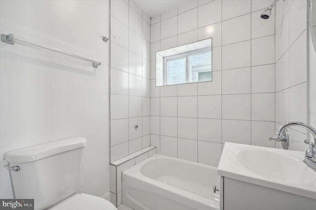 full bathroom featuring vanity, toilet, and tiled shower / bath combo