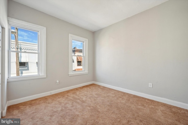 carpeted empty room with a wealth of natural light