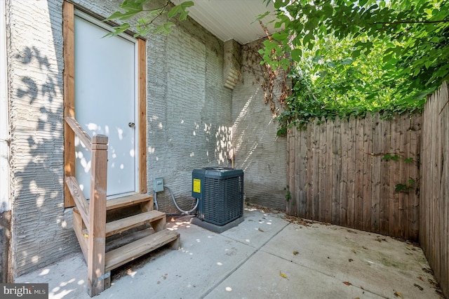 property entrance with central AC and a patio