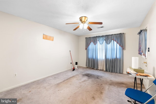 carpeted spare room with ceiling fan