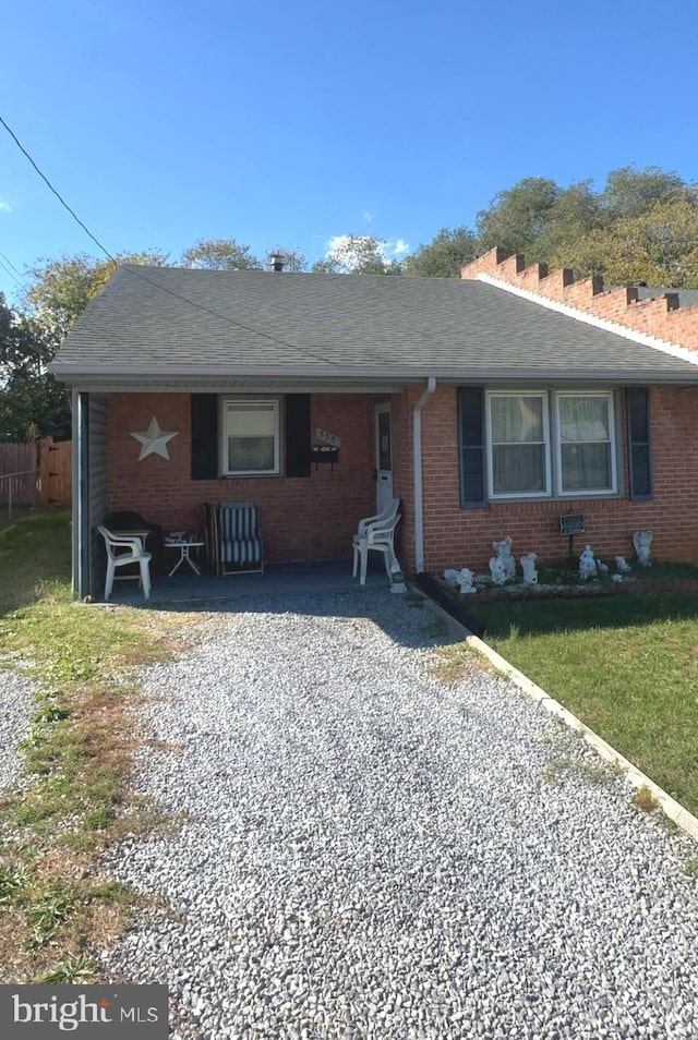 single story home with a front yard and a patio