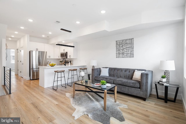 living room with light hardwood / wood-style flooring