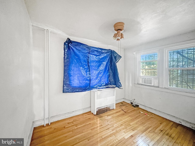 spare room with hardwood / wood-style flooring and ceiling fan