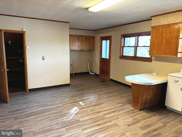 kitchen featuring ornamental molding and hardwood / wood-style flooring