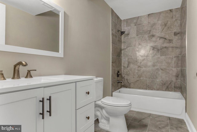 full bathroom with tiled shower / bath, vanity, and toilet