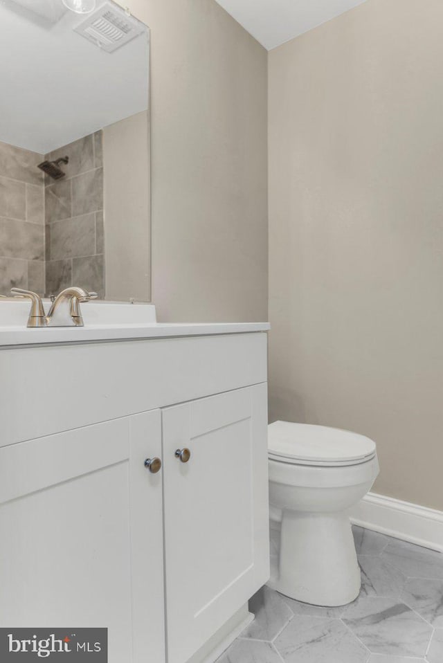 bathroom featuring vanity and toilet