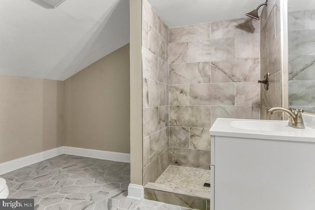 bathroom with vanity and a tile shower