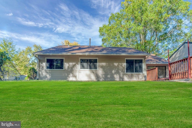 rear view of house with a lawn