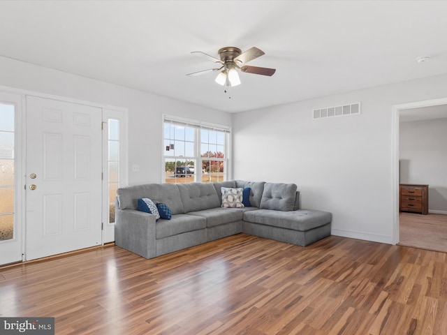 living room featuring hardwood / wood-style flooring and ceiling fan