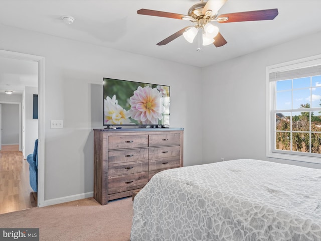 bedroom featuring ceiling fan and light colored carpet