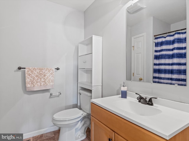 bathroom featuring vanity, toilet, and tile patterned flooring