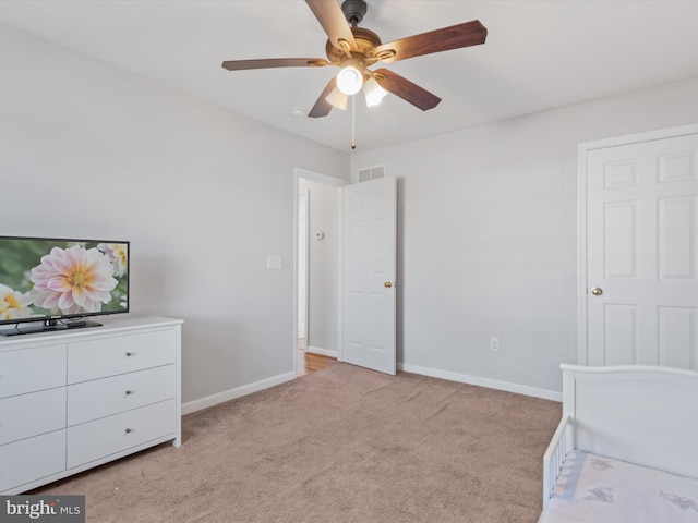 bedroom with light colored carpet and ceiling fan