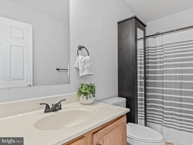 bathroom featuring toilet and vanity