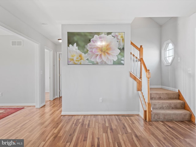 stairway with hardwood / wood-style flooring