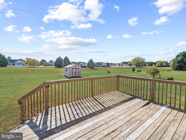 wooden terrace with a shed and a lawn