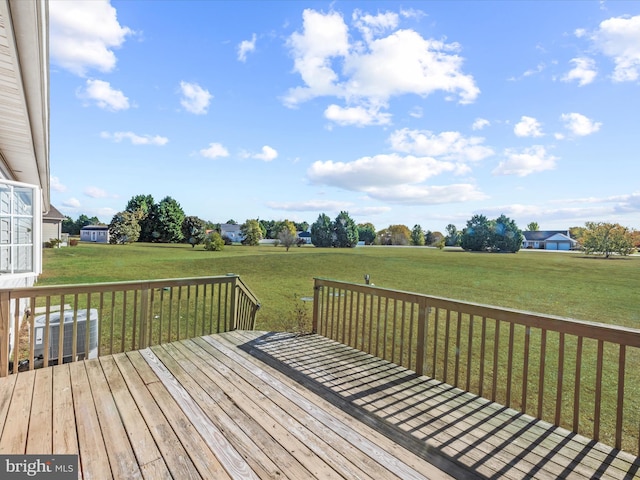 wooden deck with a lawn