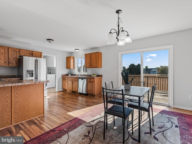 dining space featuring a notable chandelier, hardwood / wood-style flooring, and plenty of natural light